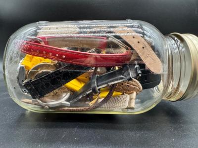 Pint jar filled with multiple watches