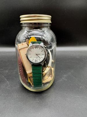 Pint jar filled with multiple watches
