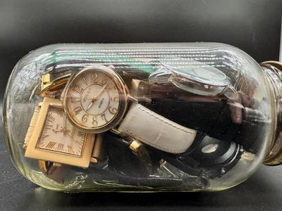 Pint jar filled with multiple watches