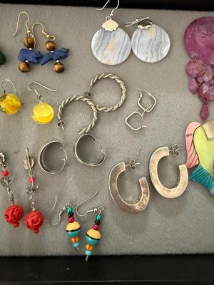 Sale Photo Thumbnail #237: This is a great lot of earrings. As you can see in the pictures there is silver chunky earrings and there’s other silver earrings. I’m not sure if they are complete silver or sterling because they’re not marked there’s marble earrings which I thin