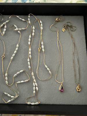Sale Photo Thumbnail #289: The two silver pieces on the left of pink earrings are sterling necklace and bracelet. There are two beautiful necklaces in the middle with that freshwater pearl look. There are two gold tone necklaces as well.