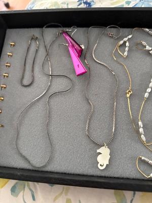 Sale Photo Thumbnail #290: The two silver pieces on the left of pink earrings are sterling necklace and bracelet. There are two beautiful necklaces in the middle with that freshwater pearl look. There are two gold tone necklaces as well.