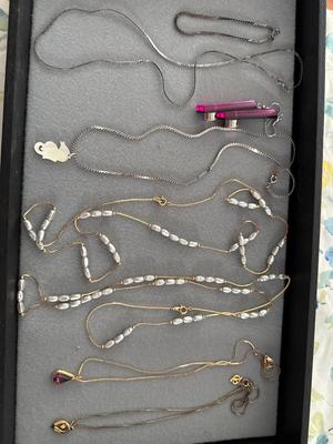 Sale Photo Thumbnail #288: The two silver pieces on the left of pink earrings are sterling necklace and bracelet. There are two beautiful necklaces in the middle with that freshwater pearl look. There are two gold tone necklaces as well.
