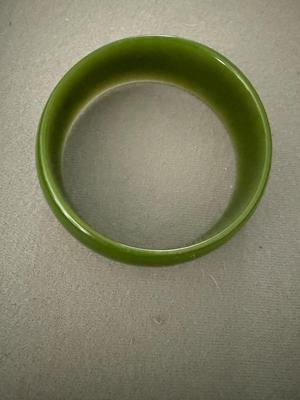 Sale Photo Thumbnail #332: This bracelet tested positive for Bakelite but it was more a brown than yellow color. It’s very pretty. It has a design of a leave and berry inside. It’s very subtle.