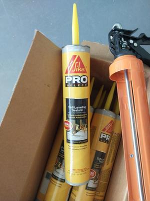 BOX OF PRO SELF LEVELING SEALENT AND CAULKING GUN