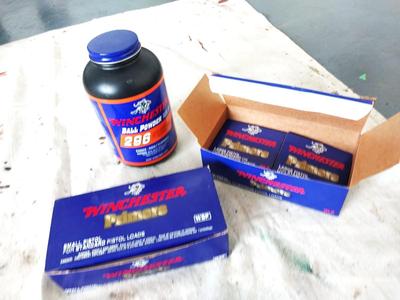 TWO WINCHESTER PREMERS AND BOTTLE BALL POWDER