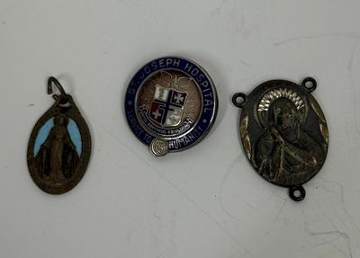 Sale Photo Thumbnail #109: 15 Year service pin for St. Joseph's Hospital, Sterling Silver Madonna medallion (2.6gh), and a Miraculous Medal from France.