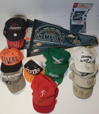 LOT 165: Philadelphia Sports Memorabilia Including Autographed Hats of Jon Runyan, Brian Propp and More