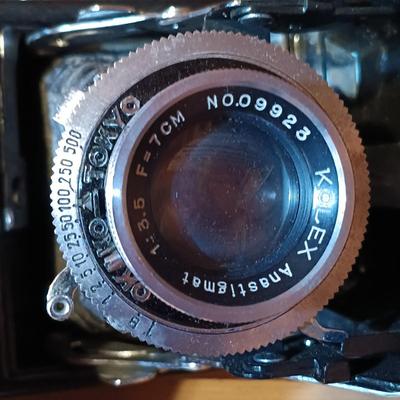 LOT 164: North American Hunting Club Collectors Coin Set and Books with Vintage Camera & Antique/Vintage Powder Horn