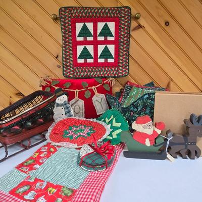 LOT 67P: Christmas Decor Including Quilted Wall Hanging, Hand-Made Coasters, Table Napkins, Cloth Basket, Round Trivets, and More