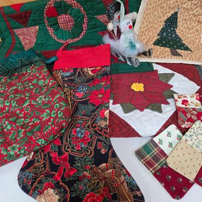LOT 69P: Beautiful Hand-Made Christmas Decor Including Table Runners, Coasters, Two Stockings, and More