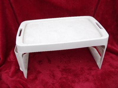 Bed tray, for eating in bed or whatever. Folds up for storage, plastic.