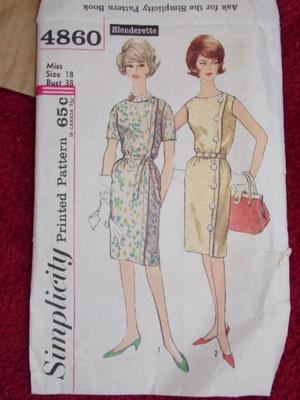 A pile of fabric in a box plus a dress pattern w/fabric & buttons,