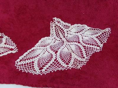 A pair of triangular crocheted doilies. Maybe for a round table.