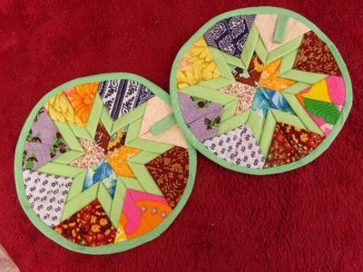 A pair of nicely made quilted hot pads, appear hand crafted.