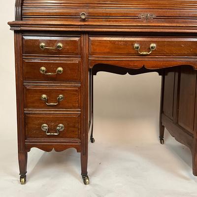 Sale Photo Thumbnail #209: Beautiful Angus of London Roll Top Tambour Desk with 8 drawers, eagle lock co brass hardware, brass pulls & know, missing one castor wheel, leather top has some wear 43" high x 48" wide x 27" deep desk height is 30.5"