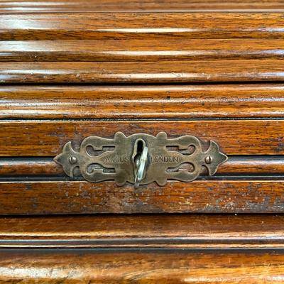 Sale Photo Thumbnail #211: Beautiful Angus of London Roll Top Tambour Desk with 8 drawers, eagle lock co brass hardware, brass pulls & know, missing one castor wheel, leather top has some wear 43" high x 48" wide x 27" deep desk height is 30.5"