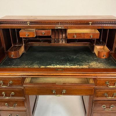 Sale Photo Thumbnail #215: Beautiful Angus of London Roll Top Tambour Desk with 8 drawers, eagle lock co brass hardware, brass pulls & know, missing one castor wheel, leather top has some wear 43" high x 48" wide x 27" deep desk height is 30.5"