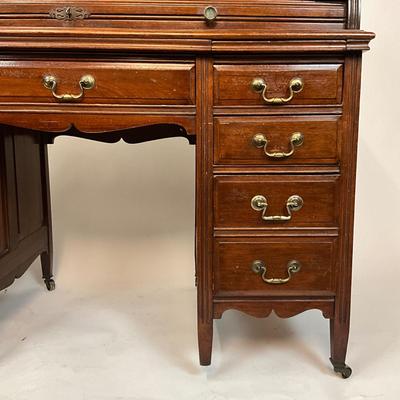 Sale Photo Thumbnail #210: Beautiful Angus of London Roll Top Tambour Desk with 8 drawers, eagle lock co brass hardware, brass pulls & know, missing one castor wheel, leather top has some wear 43" high x 48" wide x 27" deep desk height is 30.5"