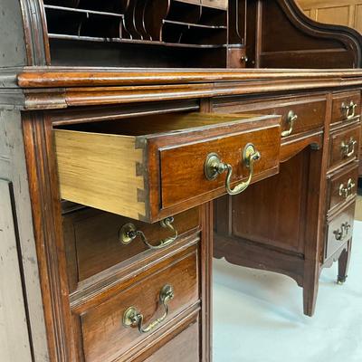 Sale Photo Thumbnail #216: Beautiful Angus of London Roll Top Tambour Desk with 8 drawers, eagle lock co brass hardware, brass pulls & know, missing one castor wheel, leather top has some wear 43" high x 48" wide x 27" deep desk height is 30.5"