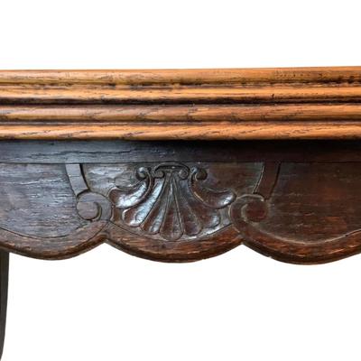 Sale Photo Thumbnail #238: Solid oak table with a burl wood top adding a rich warm patina that speaks to its age and quality. The table boasts intricate carvings along its edges and legs, showcasing the craftsmanship of the period. Its extendable design allows for versatile seating
