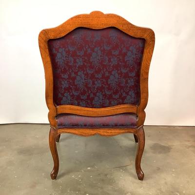 Sale Photo Thumbnail #260: magnificent example of 18th-century French craftsmanship, this Louis XV fauteuil armchair exudes elegance and comfort. Carved from rich walnut, the chair boasts a beautifully detailed frame showcasing the flowing lines and delicate asymmetry characteristi