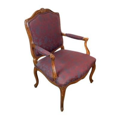 Sale Photo Thumbnail #256: magnificent example of 18th-century French craftsmanship, this Louis XV fauteuil armchair exudes elegance and comfort. Carved from rich walnut, the chair boasts a beautifully detailed frame showcasing the flowing lines and delicate asymmetry characteristi
