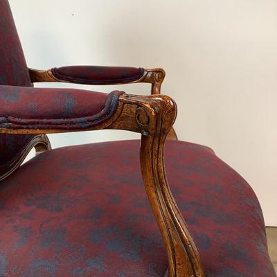 Sale Photo Thumbnail #259: magnificent example of 18th-century French craftsmanship, this Louis XV fauteuil armchair exudes elegance and comfort. Carved from rich walnut, the chair boasts a beautifully detailed frame showcasing the flowing lines and delicate asymmetry characteristi