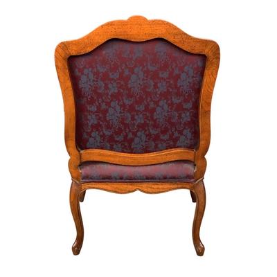Sale Photo Thumbnail #263: magnificent example of 18th-century French craftsmanship, this Louis XV fauteuil armchair exudes elegance and comfort. Carved from rich walnut, the chair boasts a beautifully detailed frame showcasing the flowing lines and delicate asymmetry characteristi
