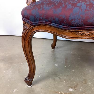 Sale Photo Thumbnail #261: magnificent example of 18th-century French craftsmanship, this Louis XV fauteuil armchair exudes elegance and comfort. Carved from rich walnut, the chair boasts a beautifully detailed frame showcasing the flowing lines and delicate asymmetry characteristi