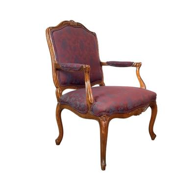 Sale Photo Thumbnail #255: magnificent example of 18th-century French craftsmanship, this Louis XV fauteuil armchair exudes elegance and comfort. Carved from rich walnut, the chair boasts a beautifully detailed frame showcasing the flowing lines and delicate asymmetry characteristi