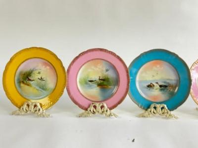 Sale Photo Thumbnail #265: Late 20th Century handprinted Avian Wildlife Plates , signed lower right in front, each plate is of a different color ( 2 yellow, 2 pink, 1-green, 1-blue) with gilt gold decorative edge. marked from the Theodore Haviland Limoges Factory very good conditio