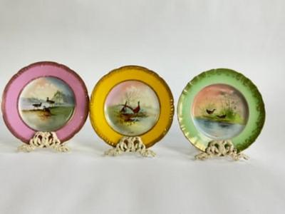 Sale Photo Thumbnail #266: Late 20th Century handprinted Avian Wildlife Plates , signed lower right in front, each plate is of a different color ( 2 yellow, 2 pink, 1-green, 1-blue) with gilt gold decorative edge. marked from the Theodore Haviland Limoges Factory very good conditio