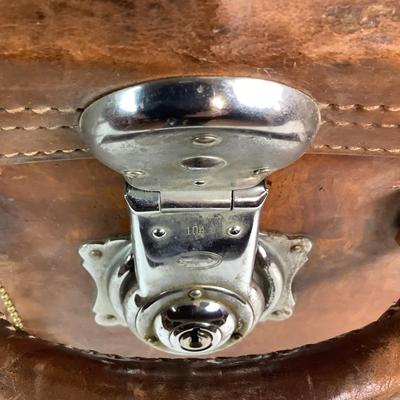 Sale Photo Thumbnail #281: Reinforced exposed straps, handles, chrome latches, includes working key, original pale blue textile interior, one ripped strapped everything else leather is intact. Rich dark leather patina. 30" wide x 11.5" high x 17" deep.