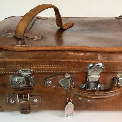 Sale Photo Thumbnail #279: Reinforced exposed straps, handles, chrome latches, includes working key, original pale blue textile interior, one ripped strapped everything else leather is intact. Rich dark leather patina. 30" wide x 11.5" high x 17" deep.