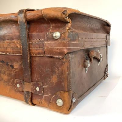 Sale Photo Thumbnail #278: Reinforced exposed straps, handles, chrome latches, includes working key, original pale blue textile interior, one ripped strapped everything else leather is intact. Rich dark leather patina. 30" wide x 11.5" high x 17" deep.