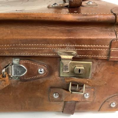 Sale Photo Thumbnail #280: Reinforced exposed straps, handles, chrome latches, includes working key, original pale blue textile interior, one ripped strapped everything else leather is intact. Rich dark leather patina. 30" wide x 11.5" high x 17" deep.