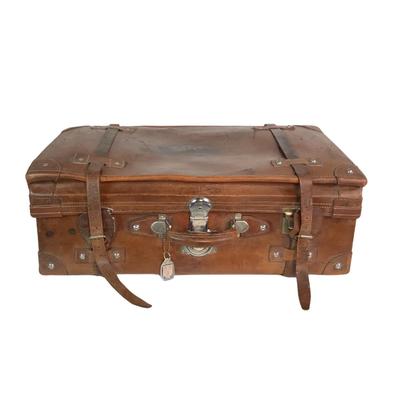 Sale Photo Thumbnail #273: Reinforced exposed straps, handles, chrome latches, includes working key, original pale blue textile interior, one ripped strapped everything else leather is intact. Rich dark leather patina. 30" wide x 11.5" high x 17" deep.