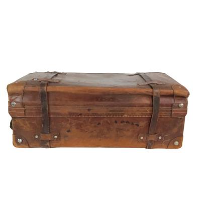 Sale Photo Thumbnail #276: Reinforced exposed straps, handles, chrome latches, includes working key, original pale blue textile interior, one ripped strapped everything else leather is intact. Rich dark leather patina. 30" wide x 11.5" high x 17" deep.