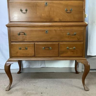 Sale Photo Thumbnail #302: This highboy is 2 piece's, made of a mix of cherry and pine; cabriole legs with fluted snake feet; on the very top center drawer it has inlay with the initials "I & B"; total of 11 drawers that are dovetail jointed, with a mixture of different brass pulls