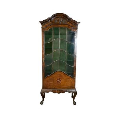 Sale Photo Thumbnail #329: 18th or early 19th century Continental vitrine, applied shell frieze at the top, arched mullions over glass, with compass inlay on the veneered bottom half, scalloped base, claw on ball feet. It has a built in light switch that plugs into the wall and it 