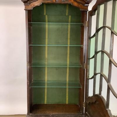 Sale Photo Thumbnail #334: 18th or early 19th century Continental vitrine, applied shell frieze at the top, arched mullions over glass, with compass inlay on the veneered bottom half, scalloped base, claw on ball feet. It has a built in light switch that plugs into the wall and it 