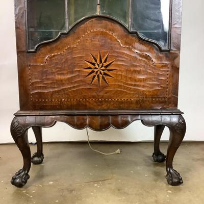 Sale Photo Thumbnail #332: 18th or early 19th century Continental vitrine, applied shell frieze at the top, arched mullions over glass, with compass inlay on the veneered bottom half, scalloped base, claw on ball feet. It has a built in light switch that plugs into the wall and it 