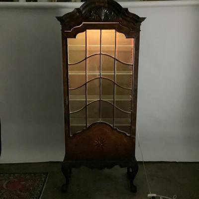 Sale Photo Thumbnail #330: 18th or early 19th century Continental vitrine, applied shell frieze at the top, arched mullions over glass, with compass inlay on the veneered bottom half, scalloped base, claw on ball feet. It has a built in light switch that plugs into the wall and it 