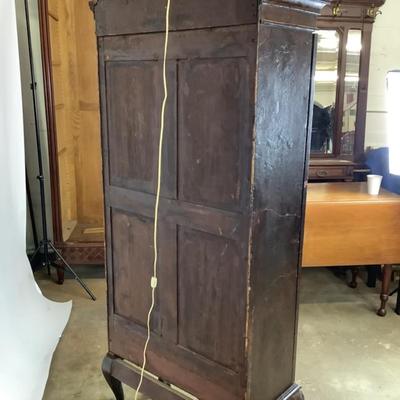 Sale Photo Thumbnail #337: 18th or early 19th century Continental vitrine, applied shell frieze at the top, arched mullions over glass, with compass inlay on the veneered bottom half, scalloped base, claw on ball feet. It has a built in light switch that plugs into the wall and it 