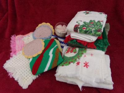 A whole pile of kitchen towels, hot pads, etc. quite the assortment.