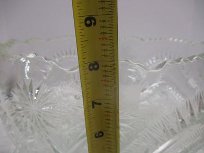 Sale Photo Thumbnail #399: The product is an antique EAPG (Early American Pattern Glass) punch bowl and underplate made by the U.S. Glass Co. The intricate design features a slanted horseshoe and radial daisy pattern, adding a touch of elegance to any dining or kitchen decor. The g