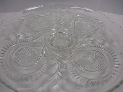 Sale Photo Thumbnail #401: The product is an antique EAPG (Early American Pattern Glass) punch bowl and underplate made by the U.S. Glass Co. The intricate design features a slanted horseshoe and radial daisy pattern, adding a touch of elegance to any dining or kitchen decor. The g