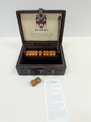 Sale Photo Thumbnail #1545: The Shut-the-Box game by GAME is a traditional game that involves rolling two dice and covering the corresponding numbers on a wooden board. Players take turns rolling the dice and trying to shut the box by covering the corresponding numbers. The game is 