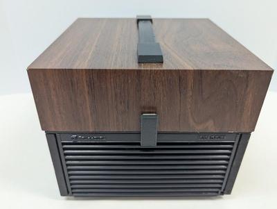 Sale Photo Thumbnail #1949: The Bell & Howell Slide Cube Projector Model 981Q is a high-quality slide projector designed by the well-known brand Bell and Howell. Featuring a unique cube design, this model allows for easy slide transitions and provides a clear and vibrant projection.